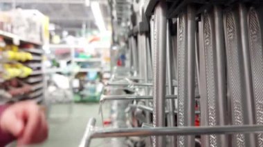 Man chooses keys for car repair in auto parts store, close-up