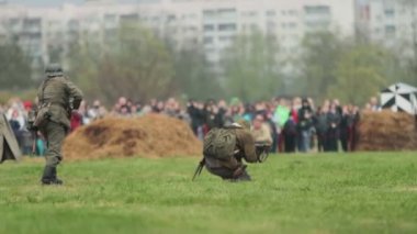 Wehrmacht Soldiers in German army uniform fire shoot gun and attack during battle reconstruction of invasion to USSR 22 June 1941 at World War 2 on Eastern front. BOBRUISK, BELARUS - MAY 9, 2021