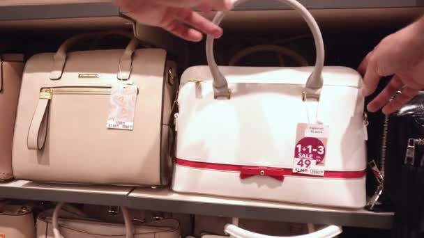 Escolhendo uma bolsa para um presente na loja. Compras de itens de moda e qualidade, close-up, compra — Vídeo de Stock