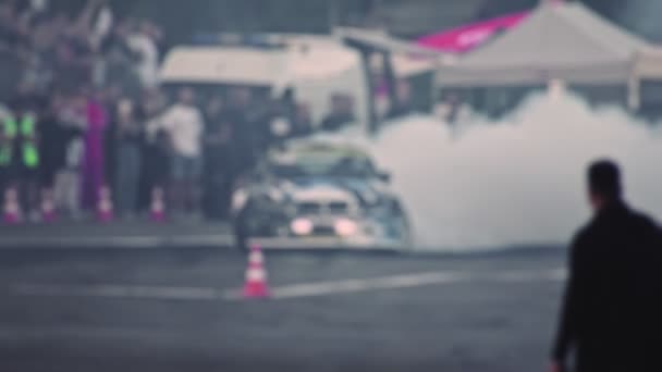 Car drifts on a sharp turn on the asphalt during the show. Racing competitions in slow motion. Smoke from under the wheels. Blurred. Professional extreme drive — Video Stock