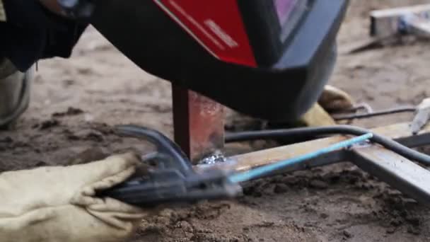 The welder knocks down scale, slag from the surfaces to be welded with a hammer during work, industry — Stock Video