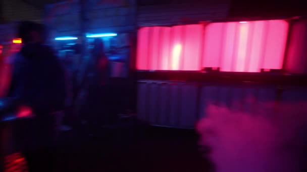 Cyberpunk future concept. Fence with signs warning about acid rain in night city with neon lighting. Danger. Science fiction scene, fantasy, sci. On set. World of tomorrow. Action shaky panoramic shot — Stock Video