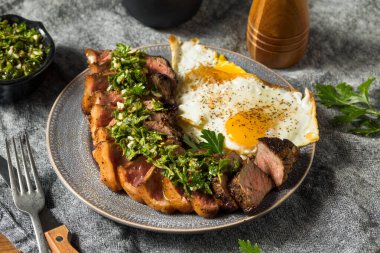 Homemade Steak and Eggs with Chimichurri Sauce clipart