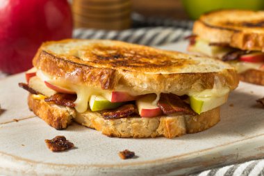 Beyaz ekmek üzerine ev yapımı domuz pastırmalı peynirli panini.