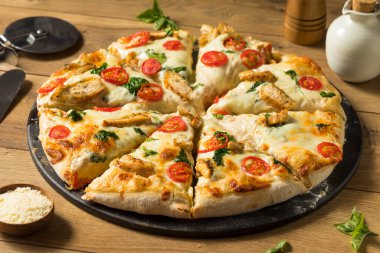 Domates ve fesleğenli ev yapımı Alfredo Pizza.