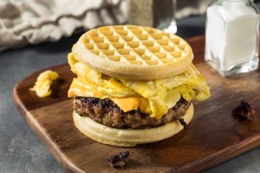 Homemade Waffle Breakfast Egg Sandwich with Cheese and Sausage