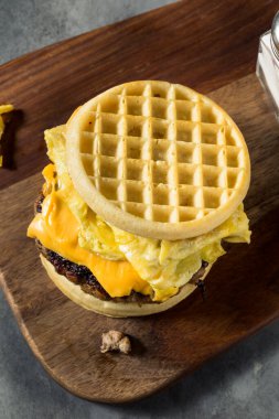 Homemade Waffle Breakfast Egg Sandwich with Cheese and Sausage