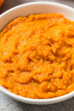 Raw Organic Cooked Pumpkin Puree in a Bowl