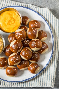 Salty Homemade Soft Pretzel Bites with Mustard and Cheese