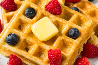 Sweet Homemade Berry Belgian Waffles with Butter and Syrup