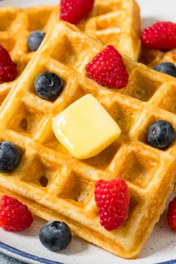 Sweet Homemade Berry Belgian Waffles with Butter and Syrup