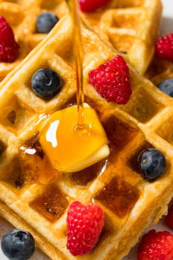 Sweet Homemade Berry Belgian Waffles with Butter and Syrup
