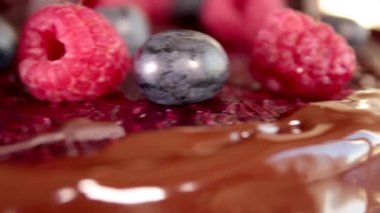 Chocolate and berry cake. Pie with strawberries and blueberries. Delicious dessert. Slider shot and close up.