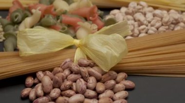 Wholemeal integral pasta, dry legumes beans, chickpeas and lentils rotating. Typical Mediterranean diet, healthy nutrition, protein, vegan or vegetarian ingredients