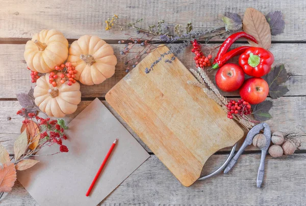 Autumn background, fallen leaves, fruits, vegetables on rustic wooden table. Seasonal set, aged vintage paper, copy space. Thanksgiving food, healthy and fresh, top view, flat lay.
