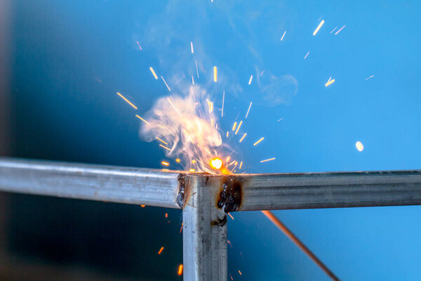 welding sparks, construction and metal work industrial concept, metal welding with sparks, laborer or labor day concept