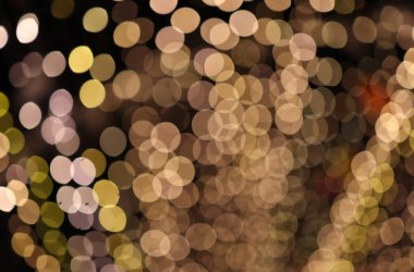 Golden bokeh light effect creating a warm and romantic atmosphere, perfect for festive or celebration background