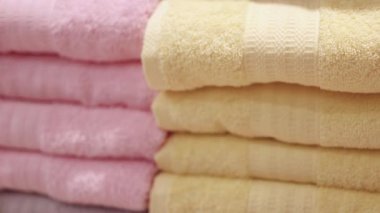 Alışveriş merkezindeki raflara düzgünce istiflenmiş havlular, sıcak ve rahat bir doku, temiz ve düzenli görünüş, ev ürünü veya perakende tanıtımı için mükemmel, yakın çekim