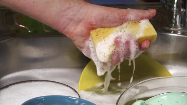 Man Washing Dishes Pressing Sponge Soap Foam Kitchen Home Slow — Stock Video