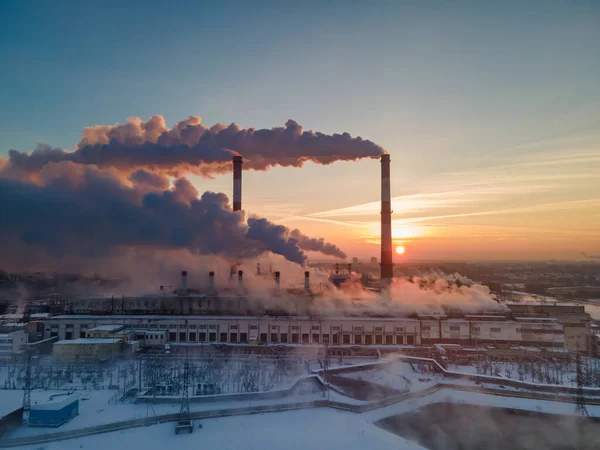 Air pollution by smoke coming out of the factory chimneys in the industrial zone. Industrial plant pipe and Global warming concept and air pollution