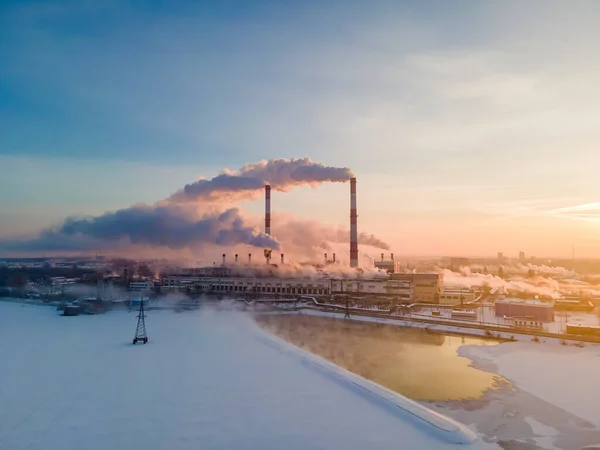 Emission smoke factory pipes in industrial zone. Ecology problem of pollution of atmosphere in cities. Aerial view of industry smokestack with carbon gases