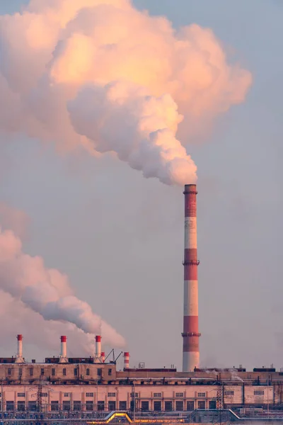 Emission gases of factory smokestack. Ecology problem of carbon pollution of atmosphere and air. Industrial pipes pollute with smoke