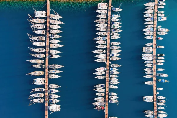 Yacht club with yachts docked in marine bay in Turkey. Aerial top view of sailboats in lagoon