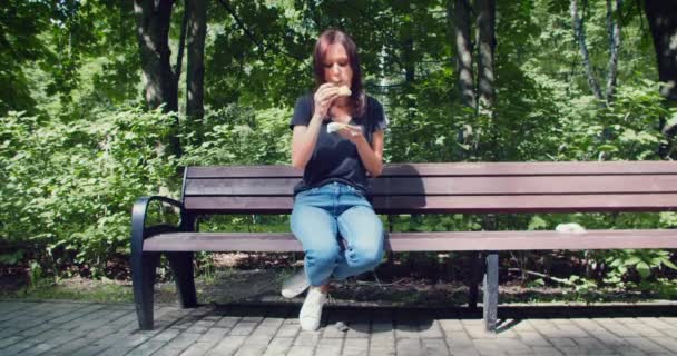 Snabbmat Och Gatumat Ohälsosamt Matkoncept Ung Kvinna Äter Hamburgare Parken — Stockvideo