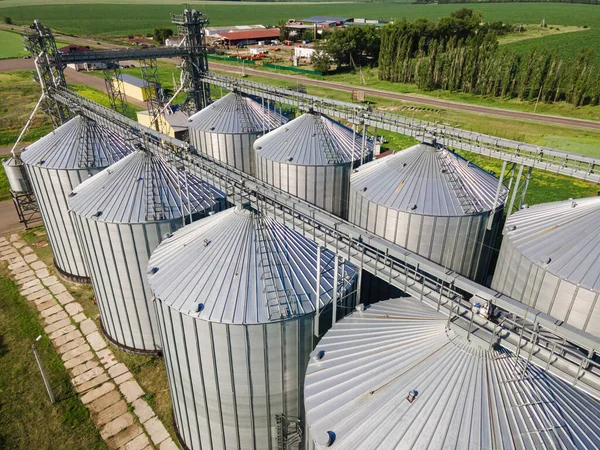 Aerial view over agricultural grain silos. Cereal plants crop storage tanks
