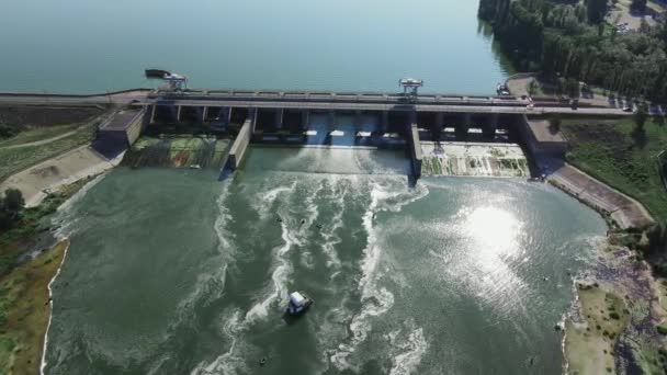 Hydroelectric dam with flowing green water through gate — Video