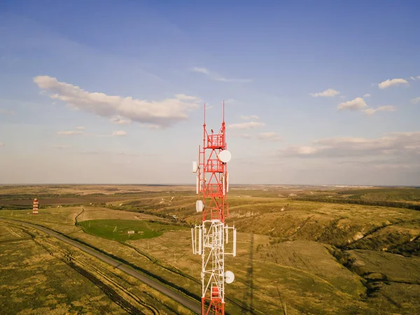 Cell site of telephone tower with 5G base station transceiver. Aerial view of telecommunication antenna mast