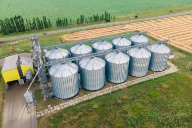 Aerial view of metal grain elevator in agricultural zone. Grain storage warehouse clipart