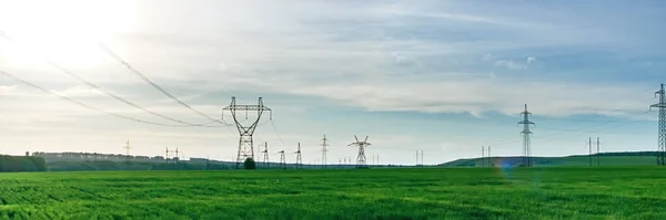 Transmission tower, power tower or electricity pylon. High-voltage powerline or overhead power line. Wide panorama