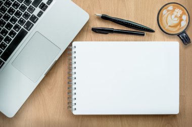 Digital tablet computer with notebook and cup of coffee