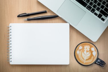 Digital tablet computerHigh angle view of a setting table of business workplace, shot in office, home work space with notebook and cup of coffee