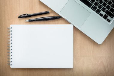Digital tablet computerHigh angle view of a setting table of business workplace, shot in office, home work space with notebook and cup of coffee