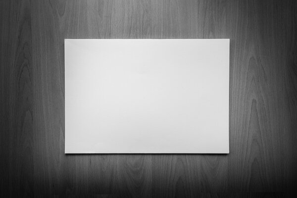 Open a blank white notebook and pen on wood background