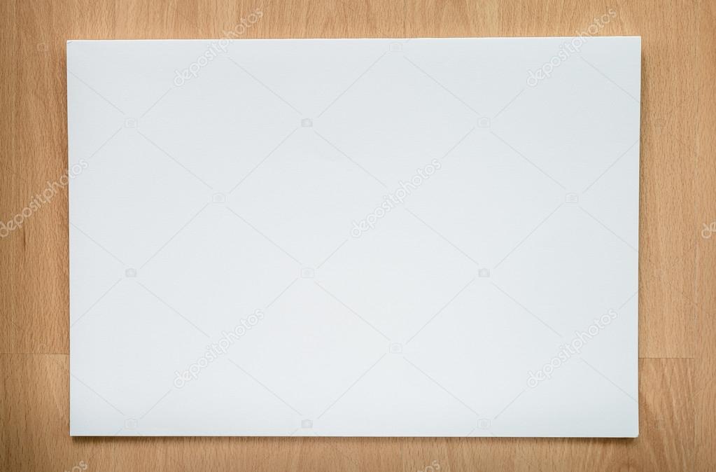 Open a blank white notebook and pen on wood background