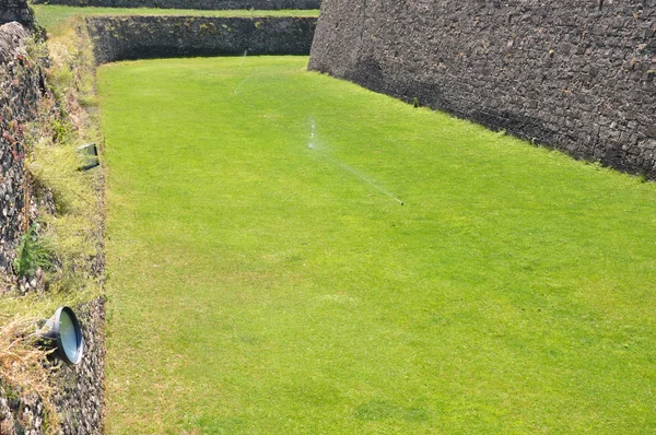 Fortification walls surrounded by grass — Stock Photo, Image