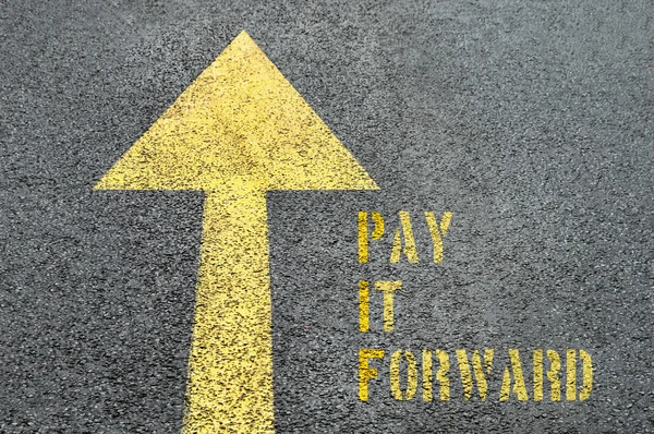 Señal amarilla hacia adelante con Pay It Forward palabra sobre el asfalto —  Fotos de Stock