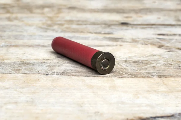 Close up of 12mm bullet on wooden table. — Stock Photo, Image