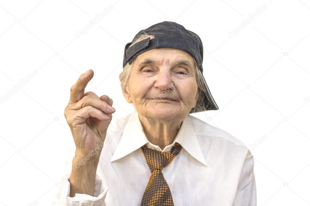 Elderly woman with cap showing middle finger.