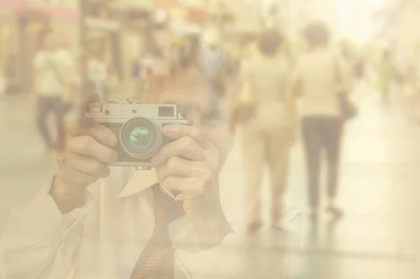 Elderly woman with camera.  Double exposure image with unrecogni — Stock Photo, Image