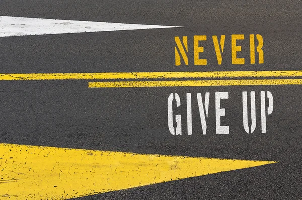 Never Give Up written on asphalt road. — Stock Photo, Image