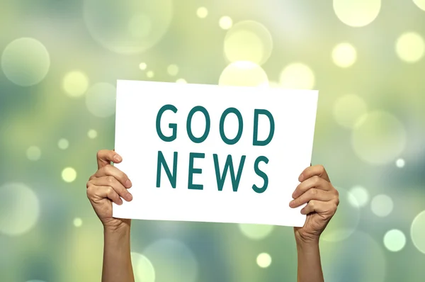 GOOD NEWS card in hand with abstract light background. — Stock Photo, Image