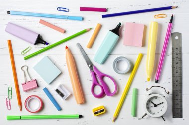 Childrens accessories for study, creativity and office supplies on a white wooden background. Back to school concept