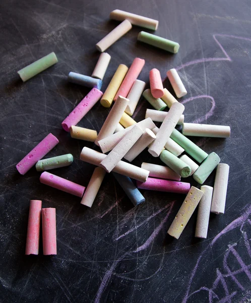 Colored chalk on the chalkboard Stock Image