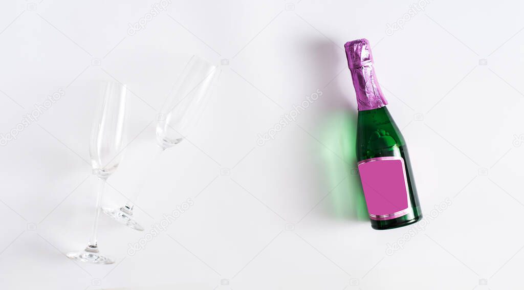 Creative flat lay composition with bottle of champagne and space for text on white background. Flat lay, copy space for text.