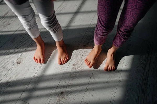 baby feet close-up on the floor, sun rays. yoga class for children