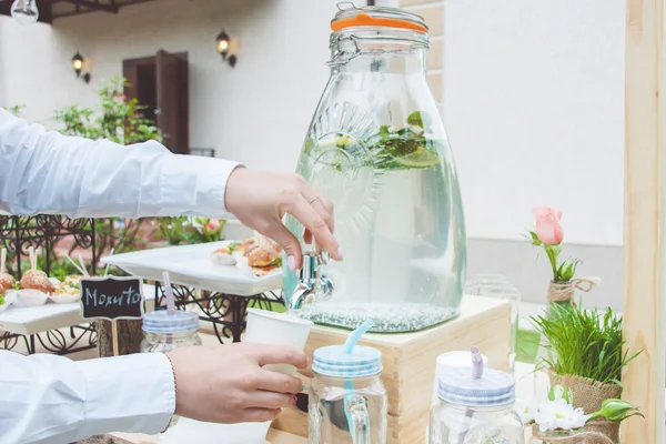 Human hands filling glass — Stock Photo, Image